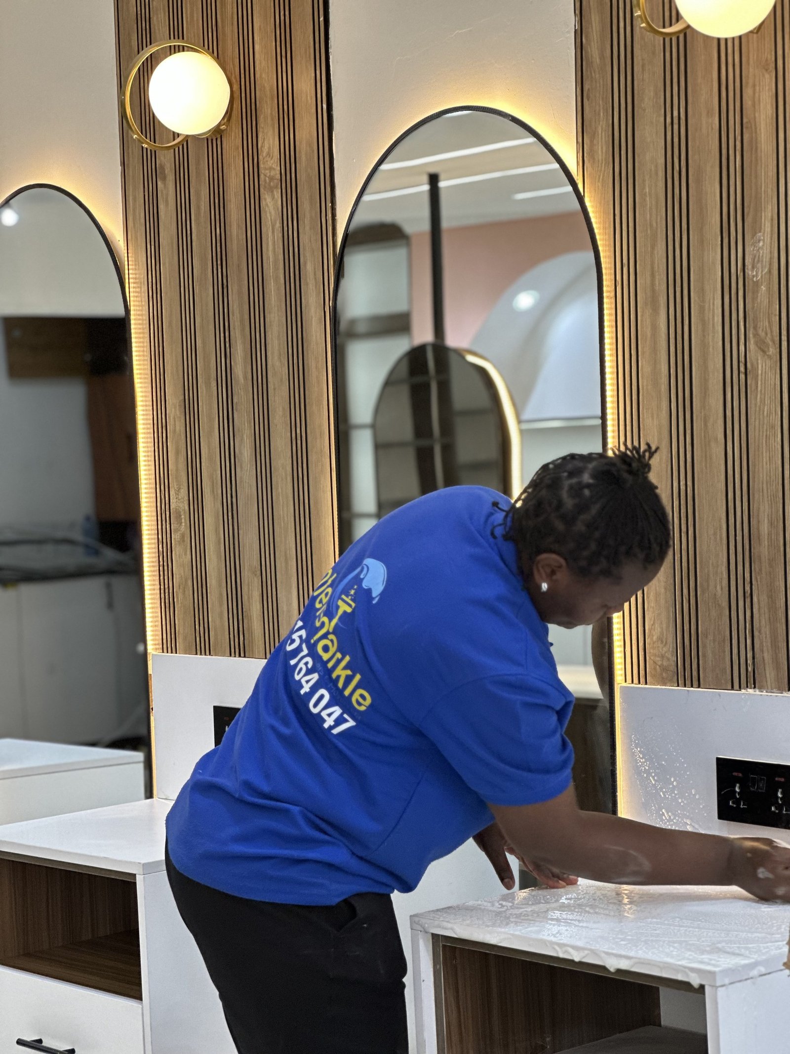Cleaner wiping a bathroom vanity
