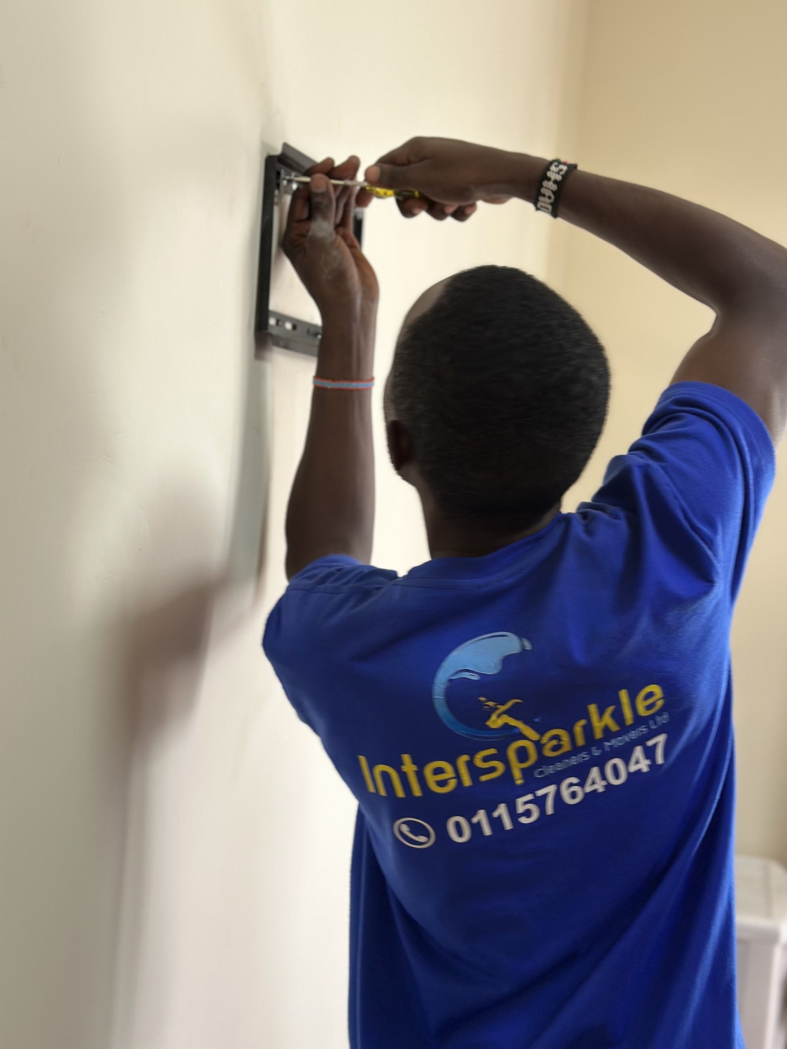 Technician mounting a TV bracket