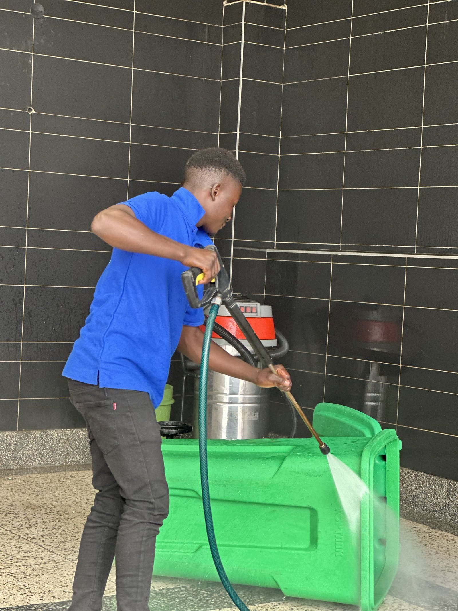 Pressure washing a bin area