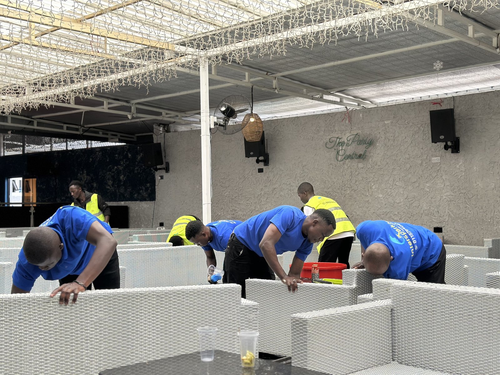Crew cleaning outdoor lounge seating